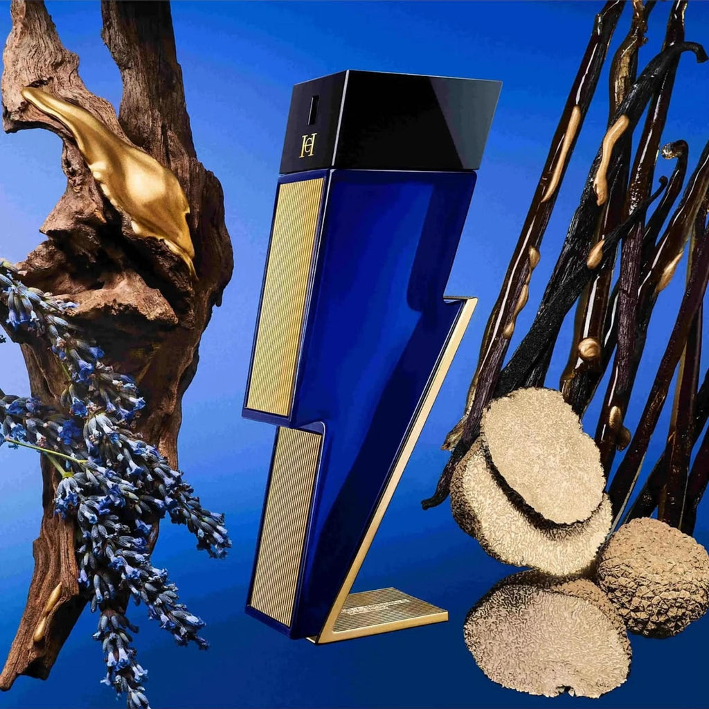 Refect Beauty Carolina Herrera Bad Boy Cobalt Absolute perfume bottle surrounded by lavender, wood, and vanilla beans.