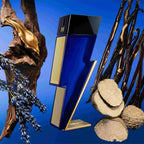 Refect Beauty Carolina Herrera Bad Boy Cobalt Absolute perfume bottle surrounded by lavender, wood, and vanilla beans.