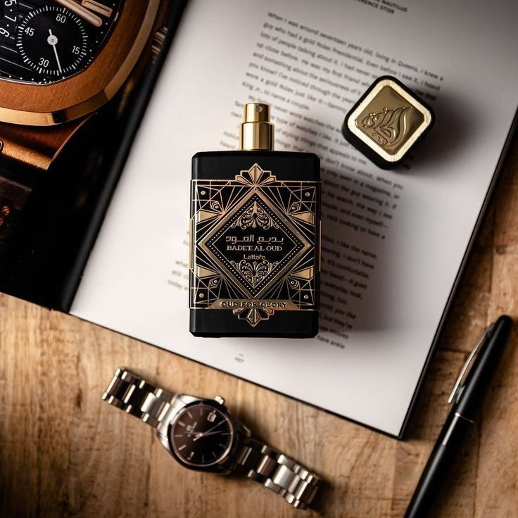 Refect Beauty Lattafa Bade’e Al Oud Oud for Glory perfume bottle with black and gold geometric label on a desk