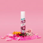 Refect Beauty Batiste Blush dry shampoo spray can surrounded by pink rose petals on a matching pink background.