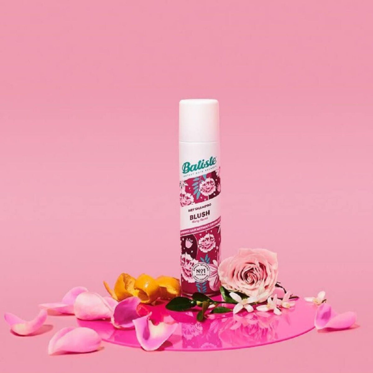 Refect Beauty Batiste Blush dry shampoo spray can surrounded by pink rose petals on a matching pink background.