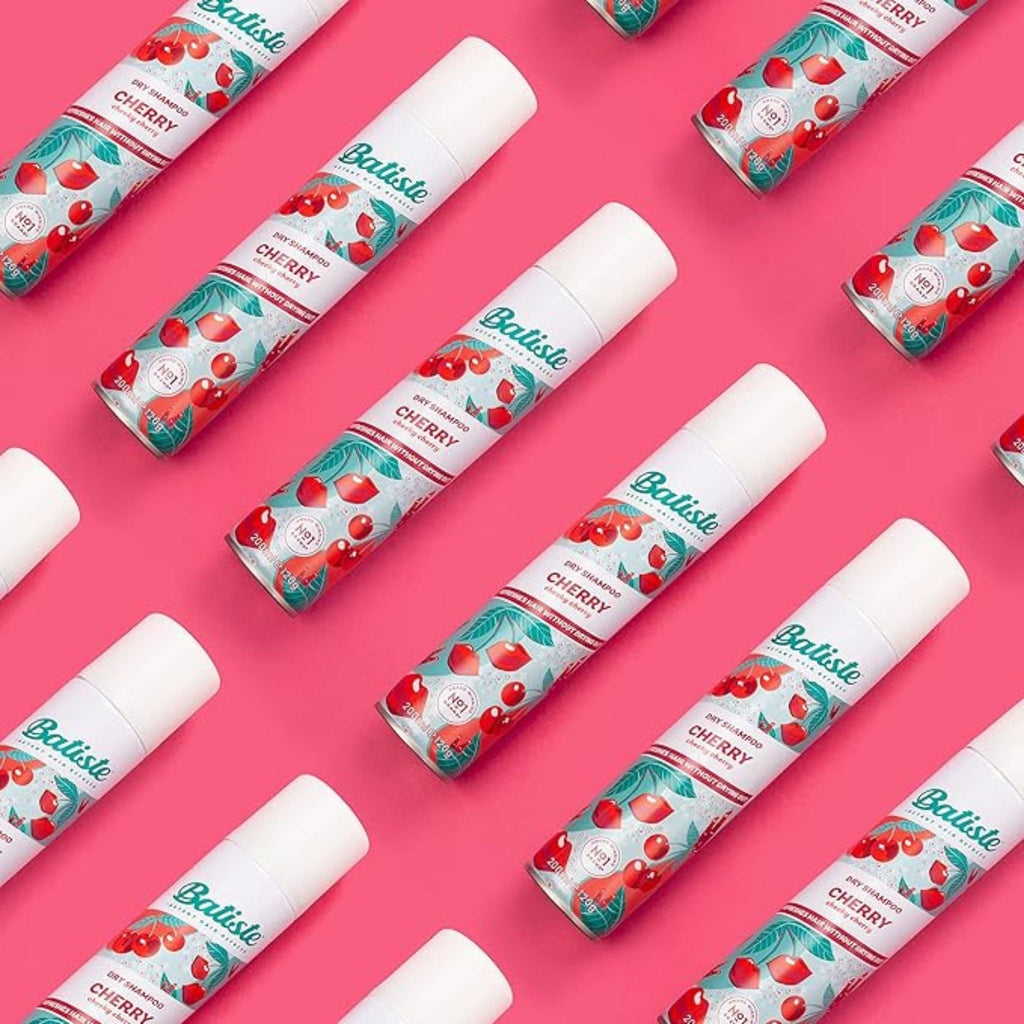 Refect Beauty Batiste Fruity & Cheeky Cherry dry shampoo cans arranged in a pattern on a bright pink background