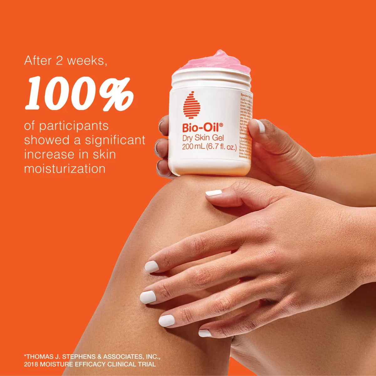 Refect Beauty Bio-Oil Dry Skin Gel jar held over a knee, showing the pink gel texture against an orange background.
