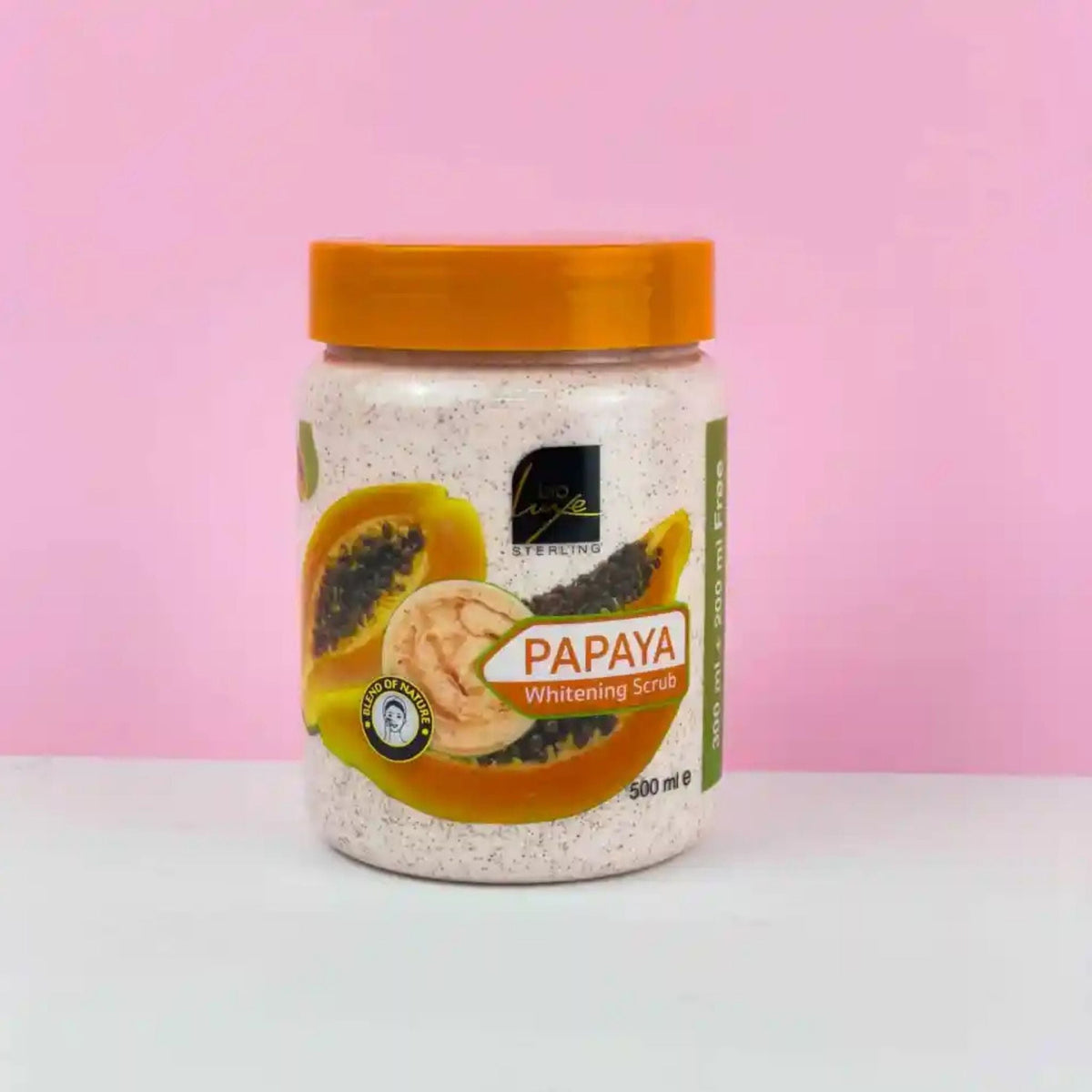 Refect Beauty Bioluxe Papaya Whitening Scrub in a 500ml jar with orange lid against a soft pink background