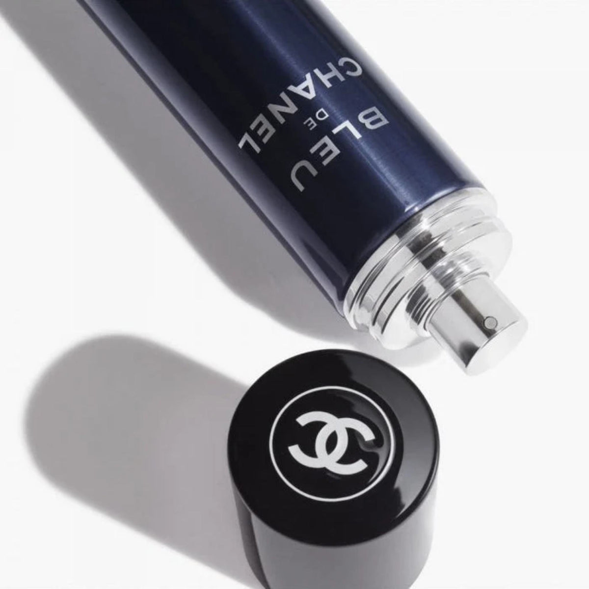 Refect Beauty Bleu de Chanel All-Over Spray in a deep blue cylindrical bottle with a black cap and silver nozzle