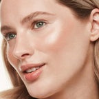 Refect Beauty model wearing Bourjois Maxi Round Pot Highlighter for a radiant, luminous glow on her cheekbones.