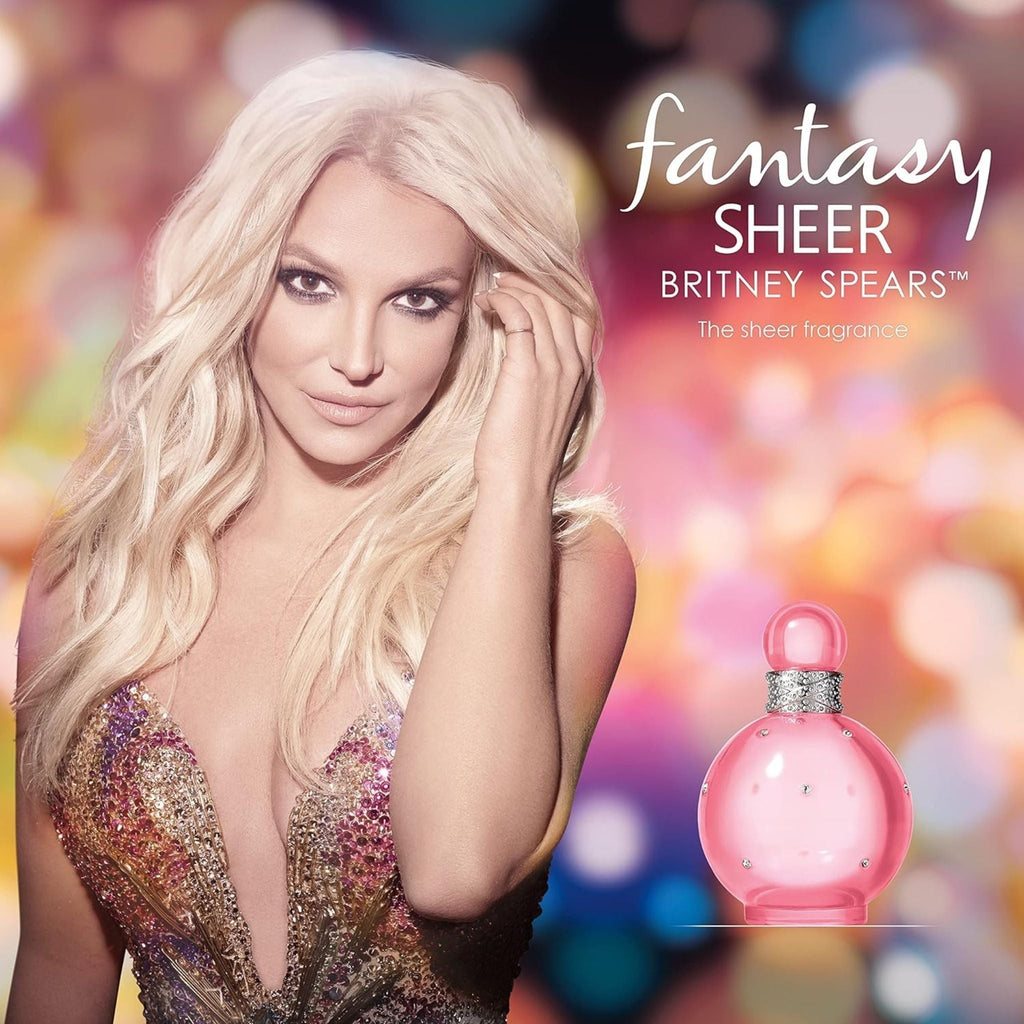 Refect Beauty Britney Spears Fantasy Sheer perfume bottle next to a portrait of Britney Spears with bokeh background
