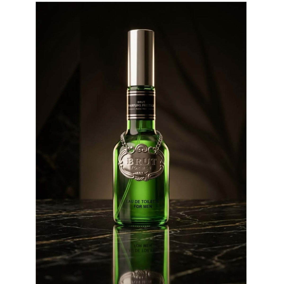 Refect Beauty Brut Original Plexi Gold Eau de Toilette in a green glass bottle with a silver medallion on marble