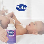 Refect Beauty Bubbles Baby Powder bottle held by a parent near a baby lying on a soft white bed