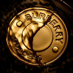 Refect Beauty Burberry Goddess Parfum gold bottle cap detail with embossed logo in a dark liquid background