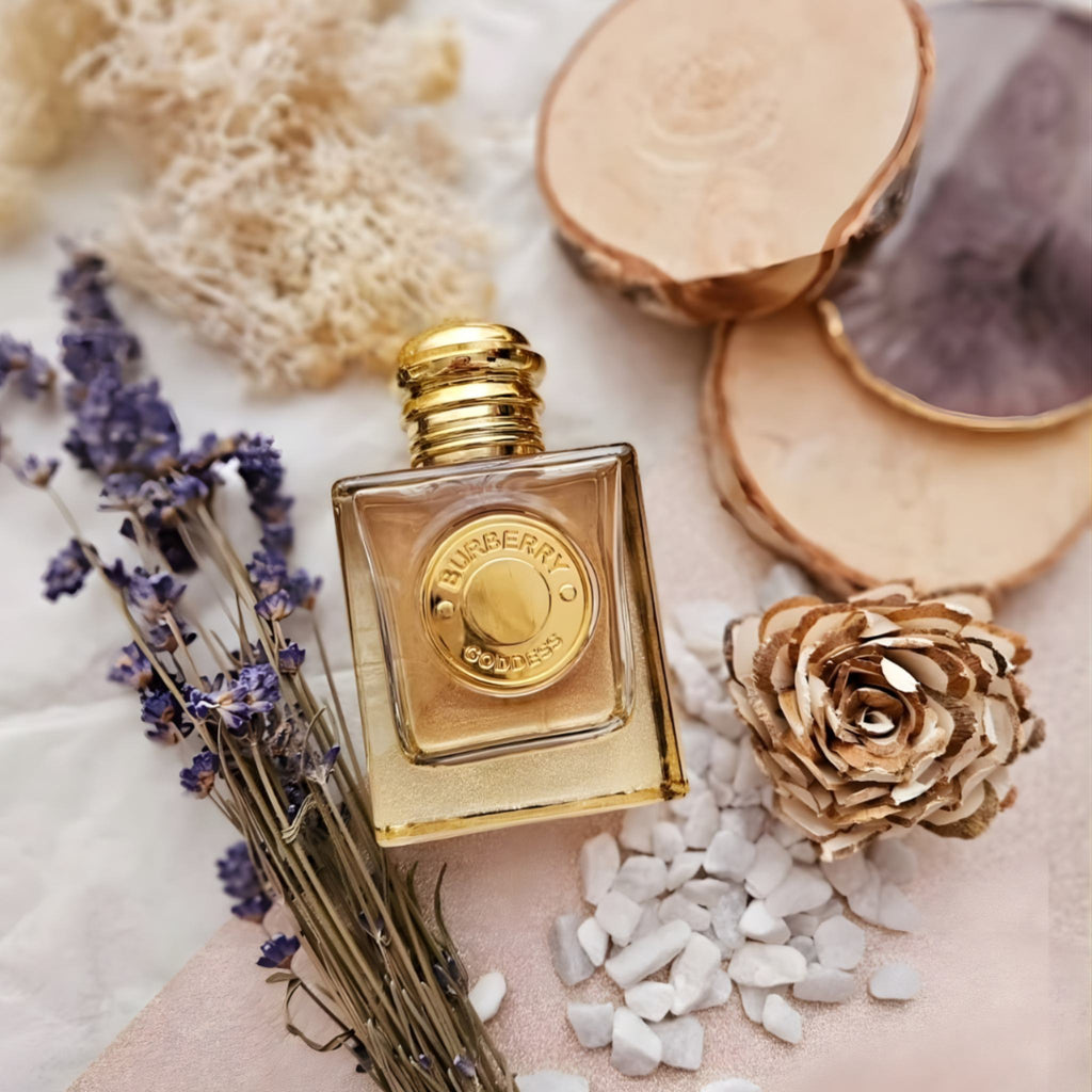 Refect Beauty Burberry Goddess Eau de Parfum bottle surrounded by dried lavender, wood slices, and white stones