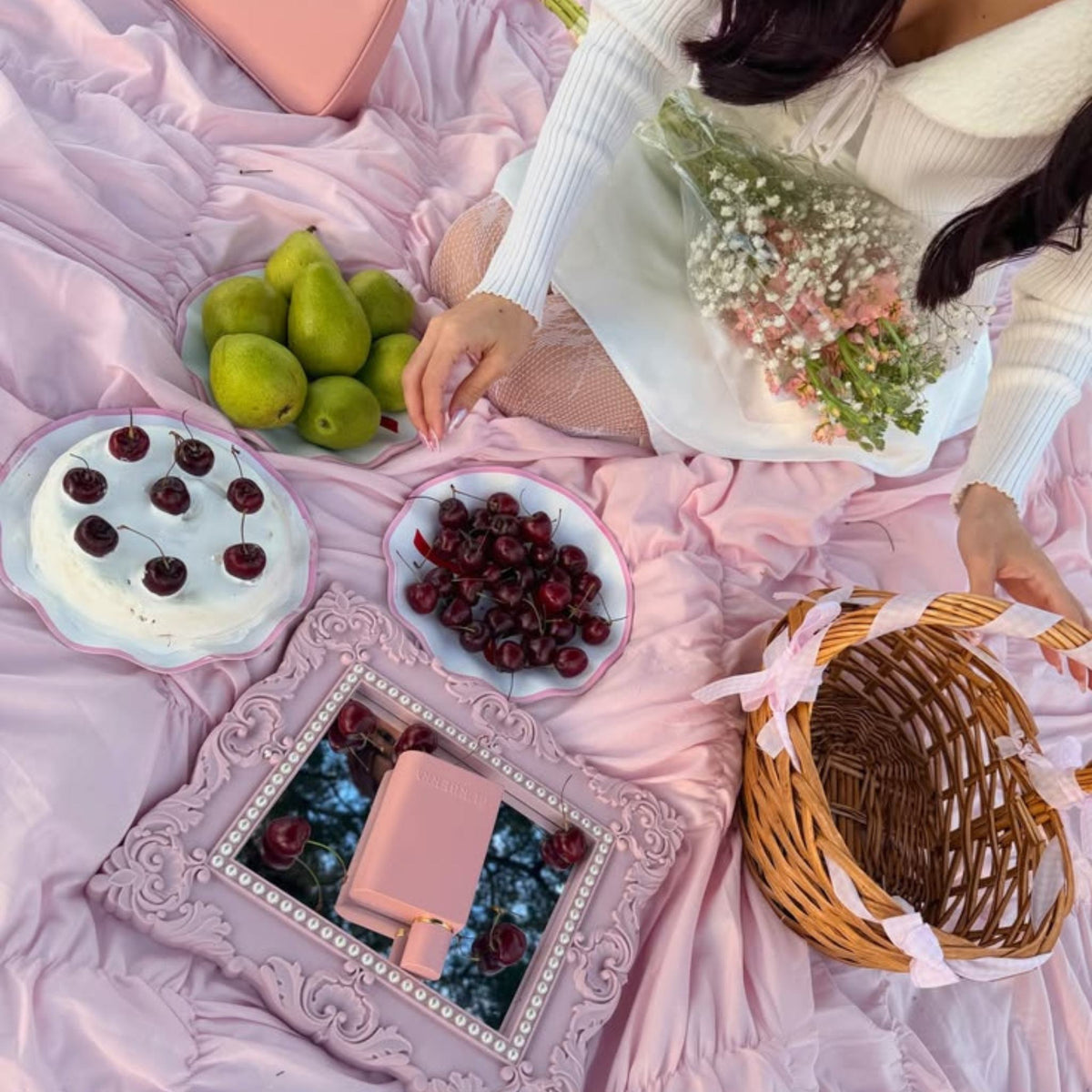 Refect Beauty Burberry Her Elixir perfume bottle on a vintage mirror at a romantic pink picnic with fruit and flowers