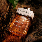 Refect Beauty Bvlgari Man Terrae Essence eau de parfum bottle resting on dark soil and natural earth elements