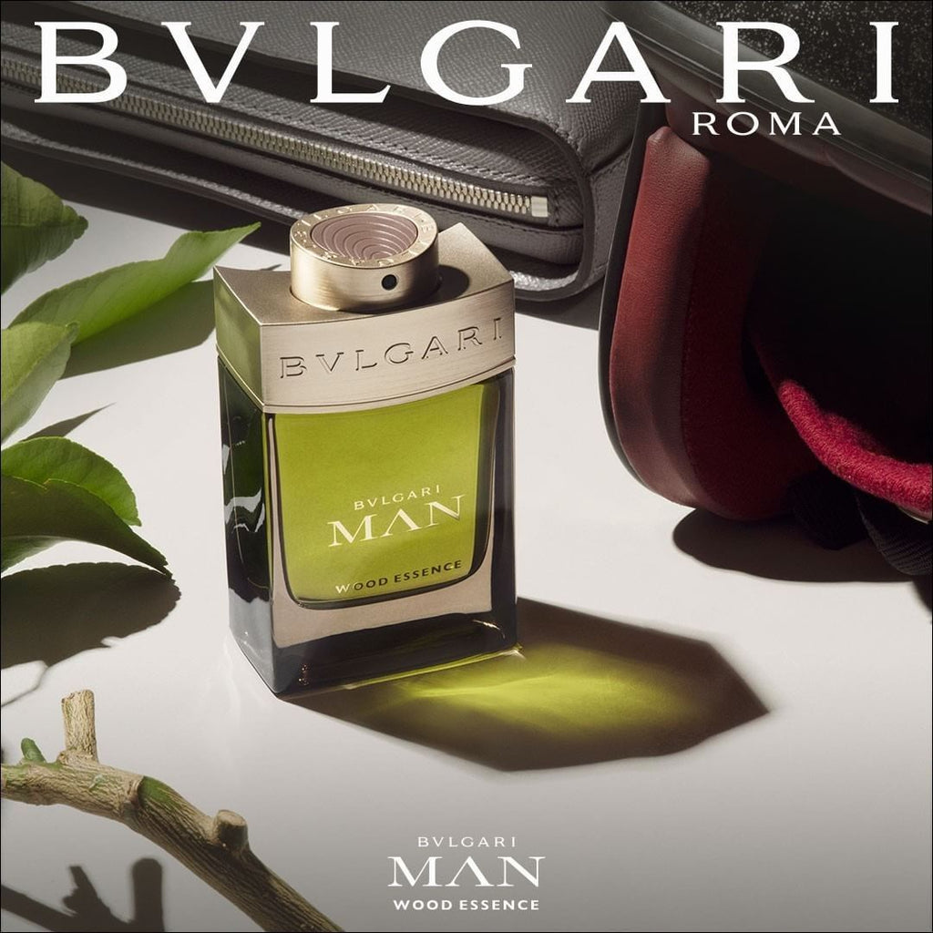 Refect Beauty Bvlgari Man Wood Essence eau de parfum bottle with green liquid and metallic cap on a modern desk