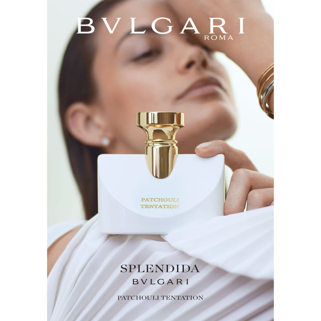 Refect Beauty Bvlgari Splendida Patchouli Tentation perfume bottle held by a woman in a white dress