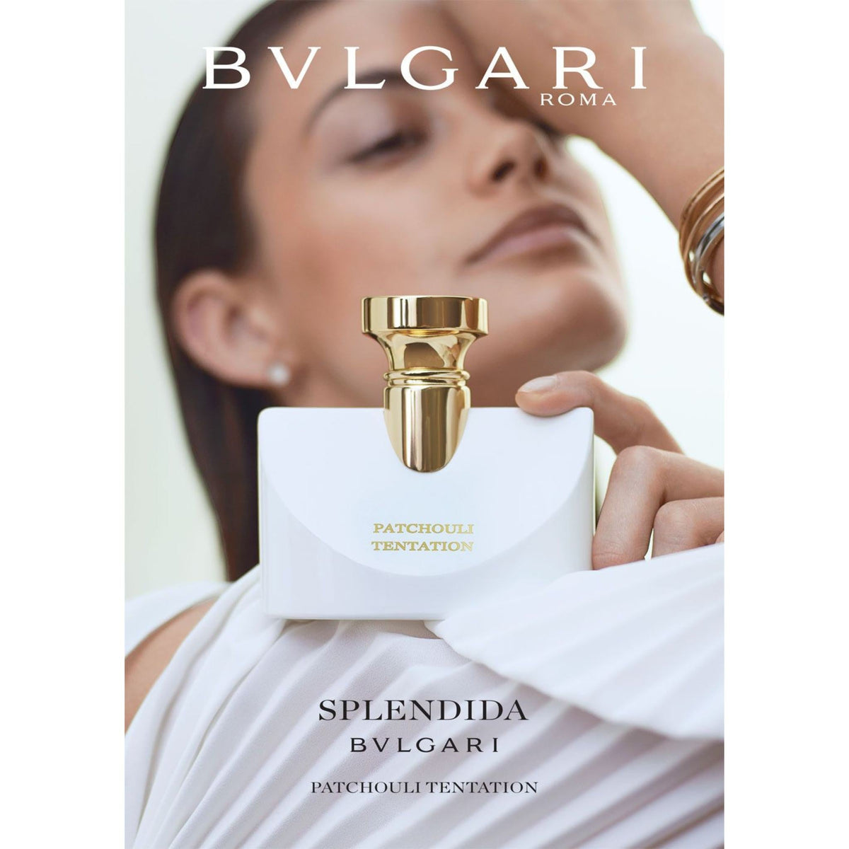 Refect Beauty Bvlgari Splendida Patchouli Tentation perfume bottle held by a woman in a white dress