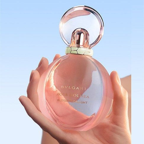 Refect Beauty Bvlgari Rose Goldea Blossom Delight perfume bottle held in hand, featuring a soft pink glass design.