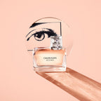 Refect Beauty Calvin Klein CK Women Eau de Parfum in a glass bottle with a circular eye graphic on a peach background
