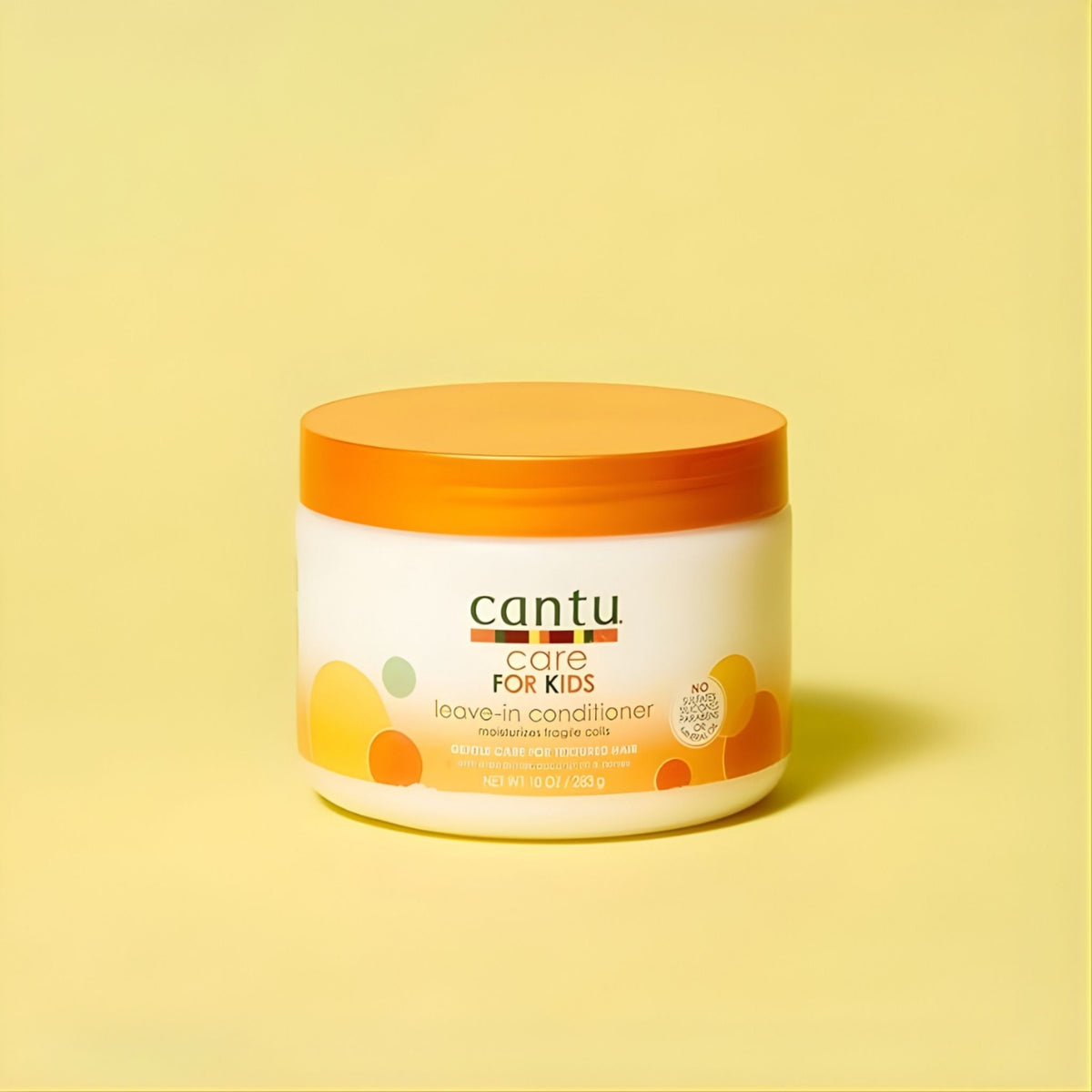 Refect Beauty Cantu Care For Kids leave-in conditioner jar with orange lid on a yellow background