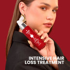 Refect Beauty Capixy Intense Tonic Spray held by a woman in a black blazer against a deep red background.