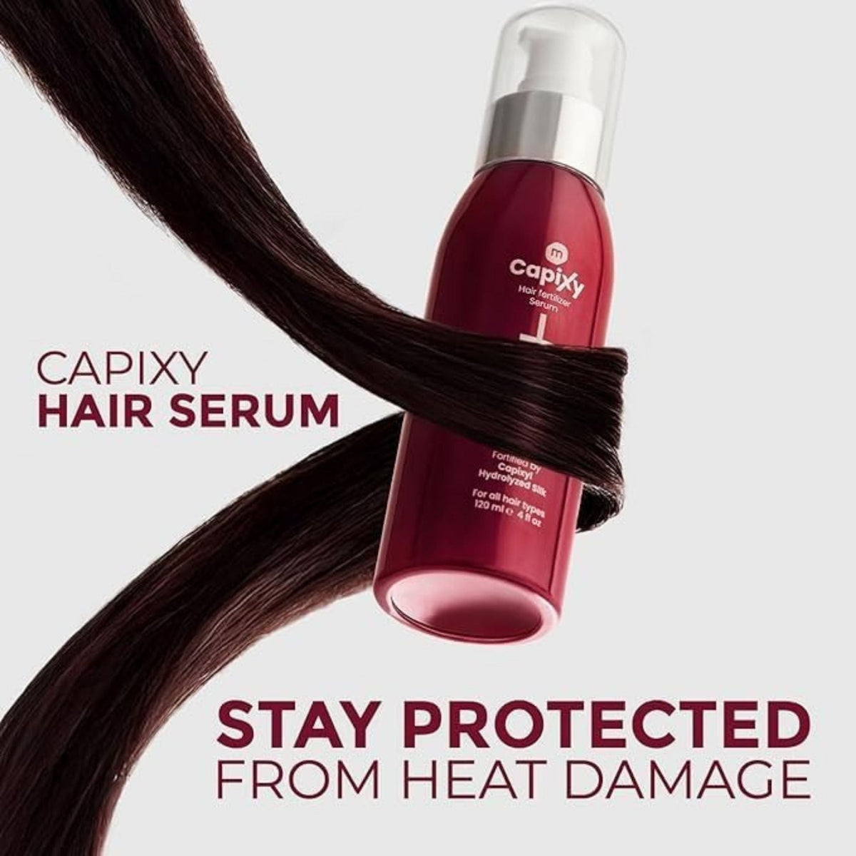 Refect Beauty Capixy hair treatment serum bottle wrapped in a strand of dark hair against a light background