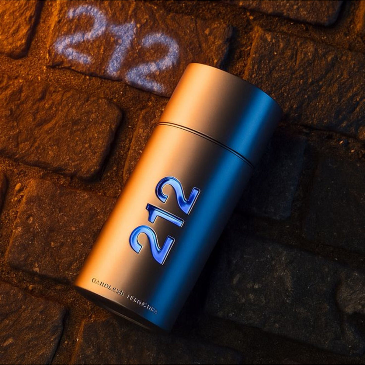Refect Beauty Carolina Herrera 212 Men NYC Eau de Toilette bottle on a textured stone surface with urban lighting