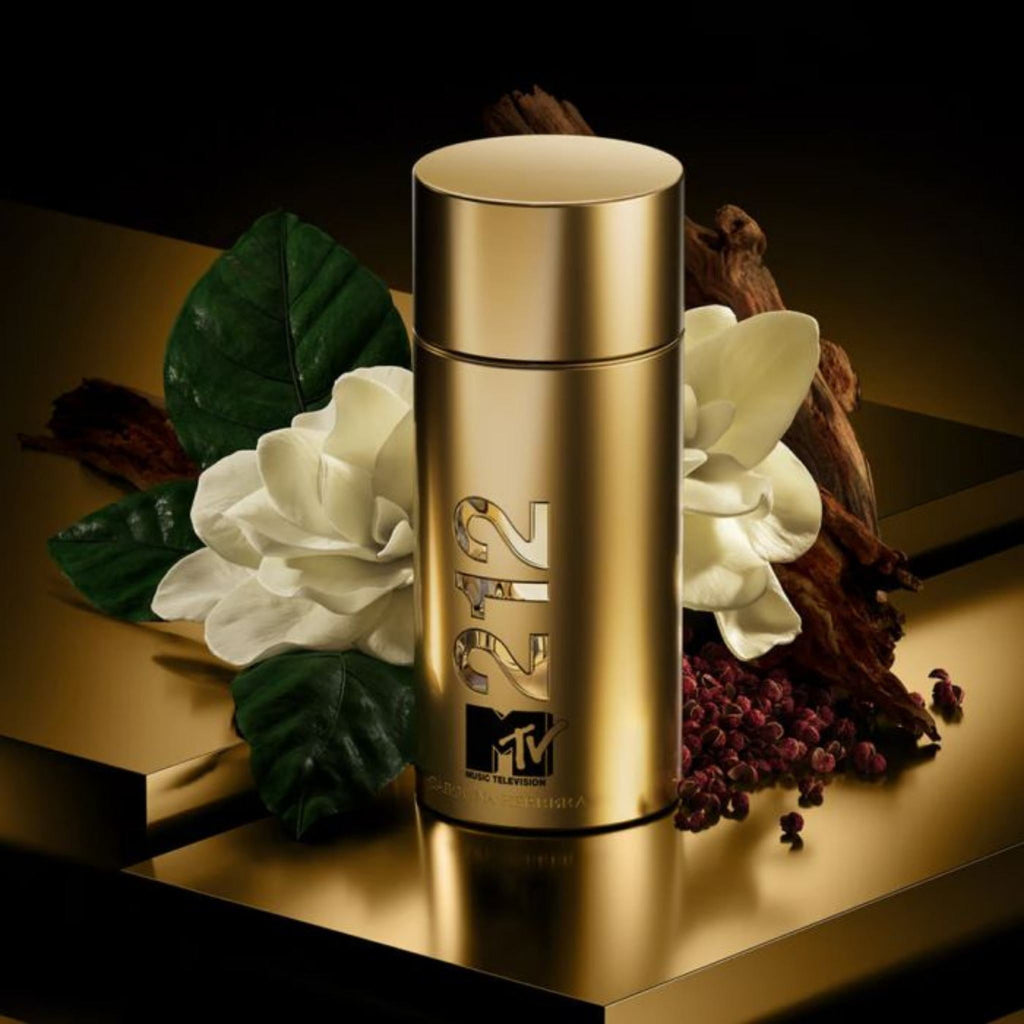 Refect Beauty Carolina Herrera 212 NYC MTV gold fragrance bottle surrounded by gardenia flowers and woody elements