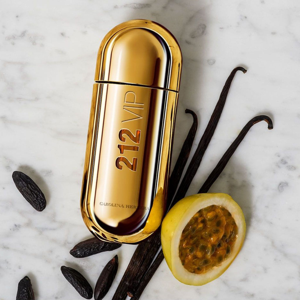 Refect Beauty Carolina Herrera 212 VIP perfume bottle in gold, surrounded by passion fruit, vanilla, and tonka beans.