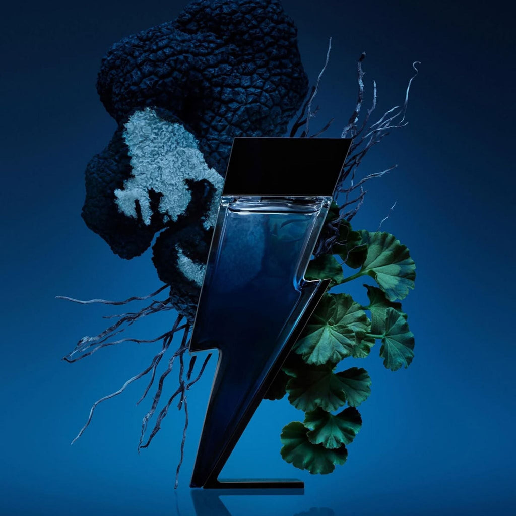 Refect Beauty Carolina Herrera Bad Boy Cobalt perfume bottle shaped like a lightning bolt against a dark blue background