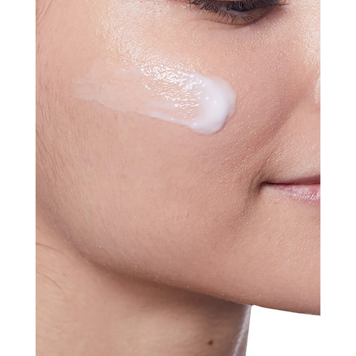 Refect Beauty CeraVe PM Facial Moisturizing Lotion applied as a smooth white cream on a woman's cheek