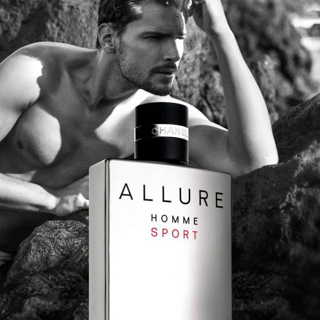 Refect Beauty Chanel Allure Homme Sport Eau de Toilette bottle next to a shirtless man on a rocky beach in black and white