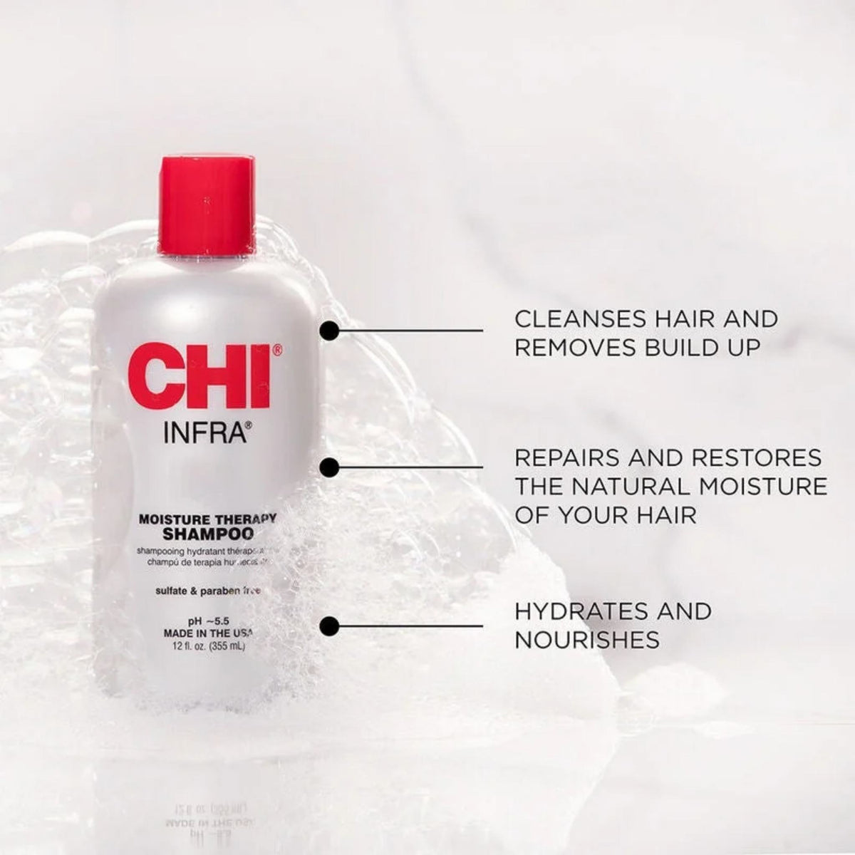 Refect Beauty CHI Infra Moisture Therapy Shampoo bottle surrounded by soap bubbles on a white marble background.
