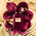 Refect Beauty Chopard Imperiale Vanille Malika perfume bottle centered on deep red orchid petals with water droplets.