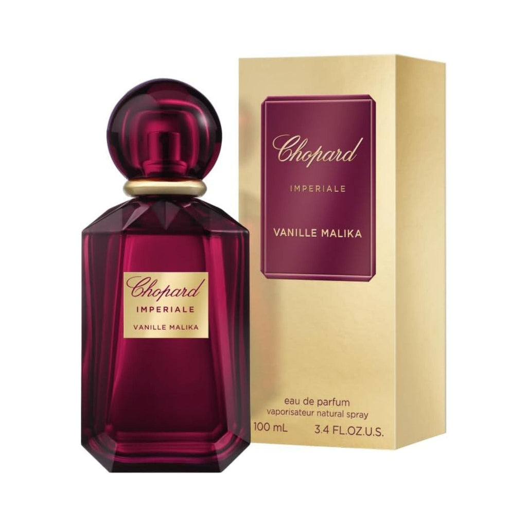 Refect Beauty Chopard Imperiale Vanille Malika perfume bottle in deep purple glass next to its gold and maroon box.