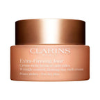 Refect Beauty Clarins Extra Firming Jour Day Rich Cream for dry skin in a peach-toned jar with a metallic bronze lid.