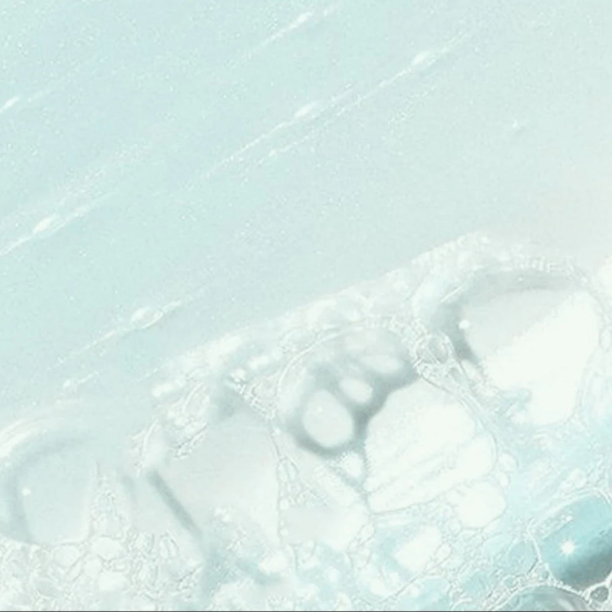 Refect Beauty Dermactive Acti-Clear gentle foaming cleansing gel texture with light bubbles on a pale blue background