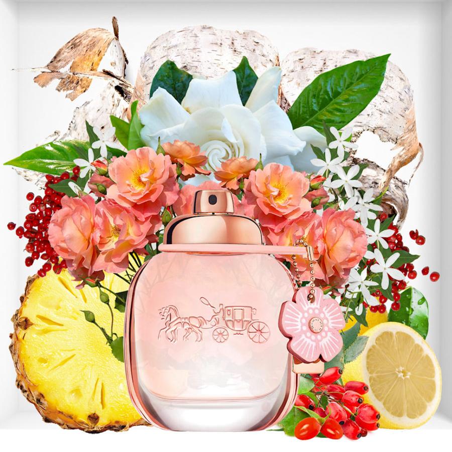 Refect Beauty Coach Floral Blush Eau de Parfum bottle surrounded by fresh flowers, pineapple, grapefruit, and berries.