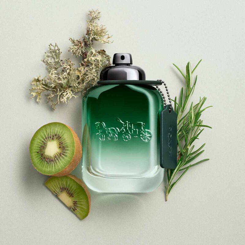 Refect Beauty Coach Green for Men Eau de Toilette bottle surrounded by fresh kiwi, rosemary, and moss ingredients.