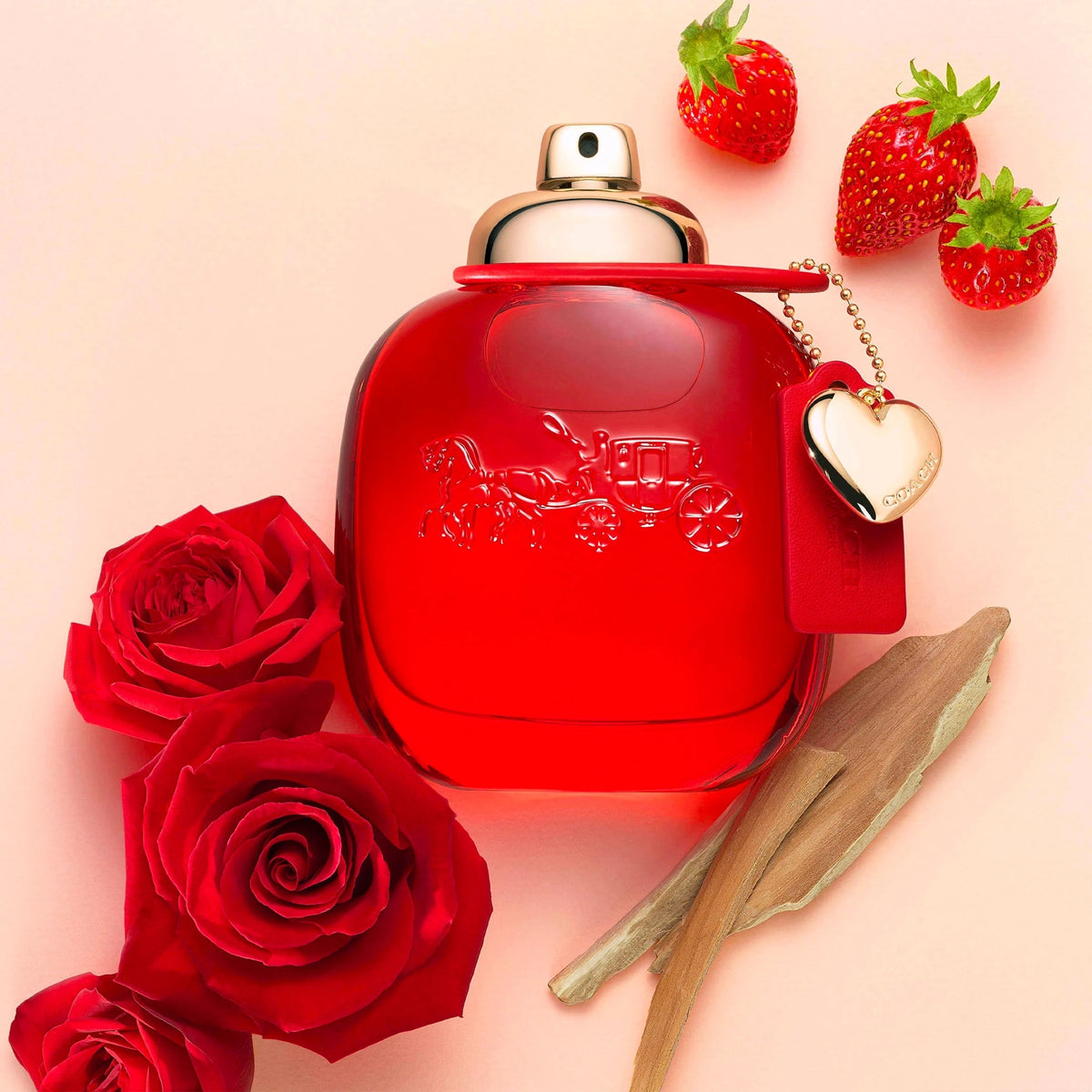 Refect Beauty Coach Love Eau de Parfum bottle surrounded by fresh strawberries, red roses, and cedarwood pieces.