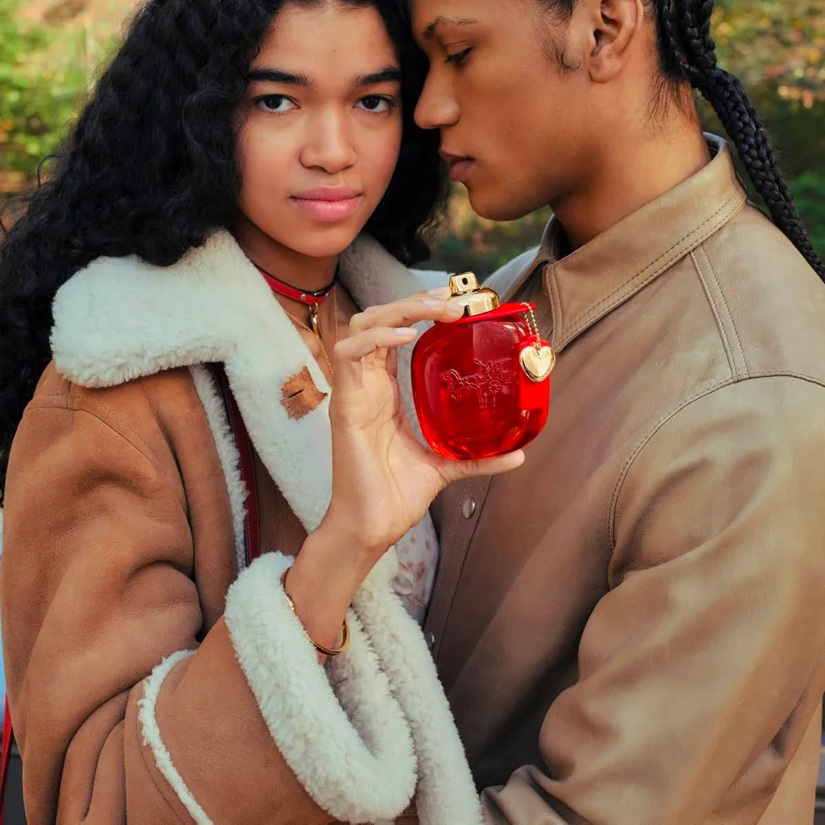 Refect Beauty Coach Love Eau de Parfum held by a woman next to a man in a romantic outdoor setting