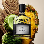 Refect Beauty Creed Aventus Eau de Parfum bottle surrounded by pineapple, bergamot, and birch wood elements