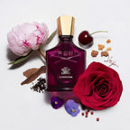 Refect Beauty Creed Carmina Eau de Parfum bottle surrounded by fresh rose, peony, cherry, and aromatic resin notes.