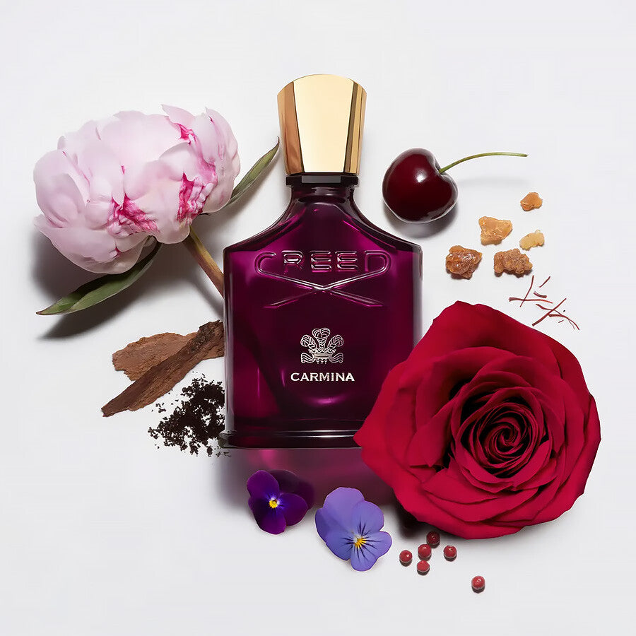 Refect Beauty Creed Carmina Eau de Parfum bottle surrounded by fresh rose, peony, cherry, and aromatic resin notes.