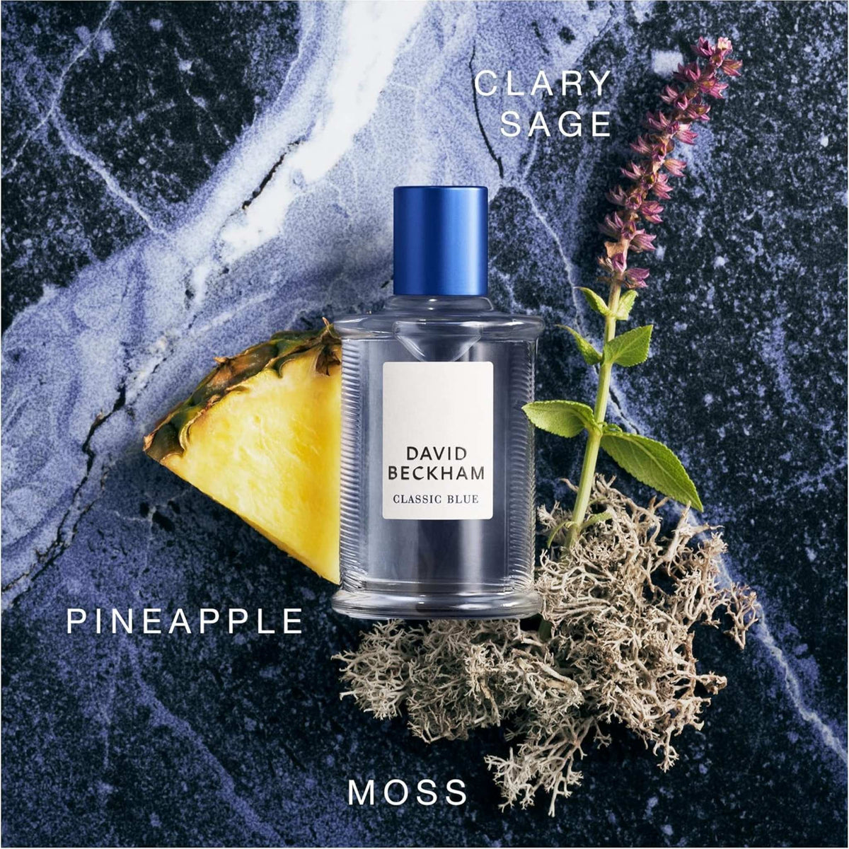 Refect Beauty David Beckham Classic Blue Eau de Toilette bottle surrounded by pineapple, clary sage, and moss