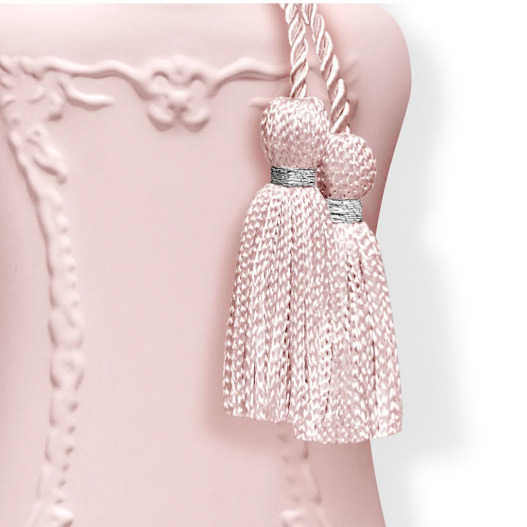 Refect Beauty Parfums de Marly Delina perfume bottle detail featuring a soft pink finish and decorative silk tassels.