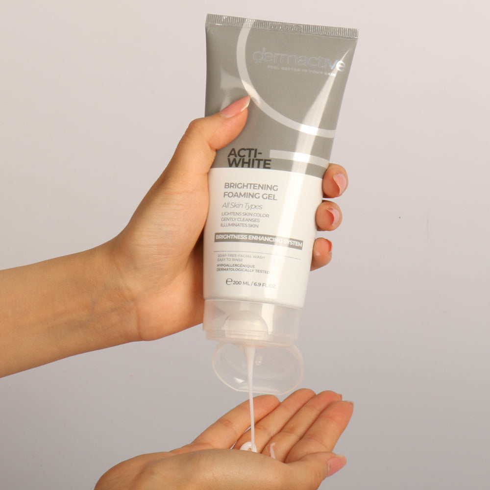 Refect Beauty Dermactive Acti-White brightening foaming gel in a grey squeeze tube being dispensed into a hand