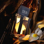 Refect Beauty Dior Homme Intense Eau de Parfum bottle surrounded by iris flowers and dark wood in warm lighting