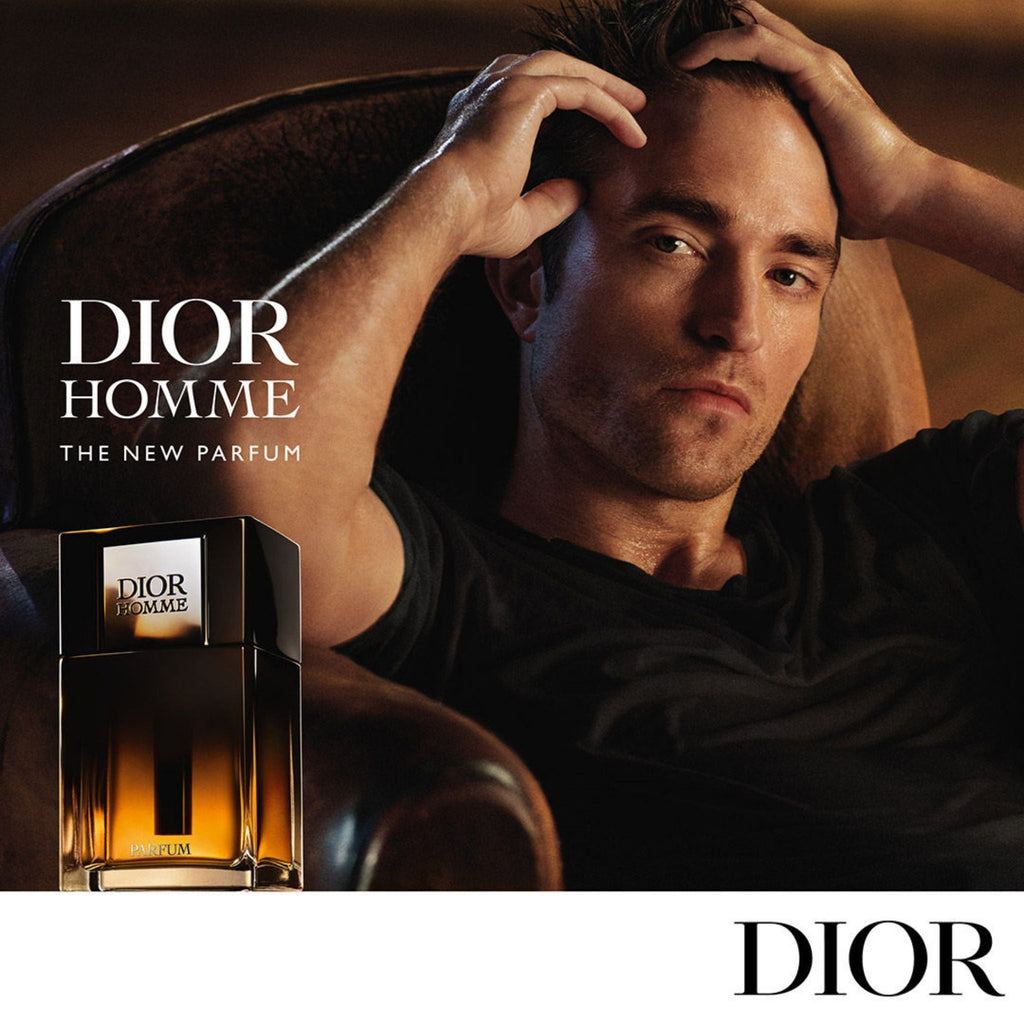 Refect Beauty Dior Homme Parfum bottle next to a man in a dark setting, showcasing a sophisticated woody iris scent.