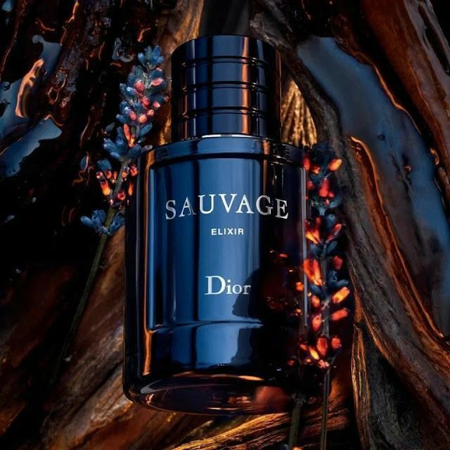 Refect Beauty Dior Sauvage Elixir perfume bottle in dark blue glass surrounded by lavender and rustic wood elements