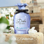 Refect Beauty Dolce & Gabbana Dolce Blue Jasmine perfume bottle with a blue flower cap and black bow on stone